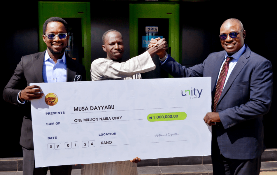 From Left: Eghomwanre Iyamu, Head, e-Business; Aisha Lawan Gana, Prize Winner, Musa Dayyabu; and Aminu Moyi, Zonal Head, North West 1 during the official cheque presentation to the winner in Kano recently.