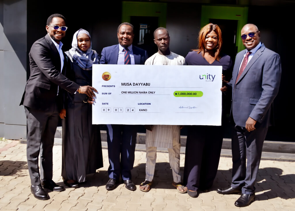 From Left: Eghomwanre Iyamu, Head, e-Business; Aisha Lawan Gana, Regional Manager, Kano North; Mahmoud Ibrahim, Regional Manager, Kano South; Prize Winner, Musa Dayyabu; Patricia Irhegbe, e-Business Sales, North West; and Aminu Moyi, Zonal Head, North West 1 during the official cheque presentation to the winner in Kano recently.